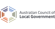 Logo of the Australian Council of Local Government with a hexagon geometric design in blue, orange, and beige tones to the left of the organization's name in grey text.